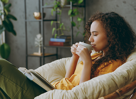 Woman relaxing with cup of coffee