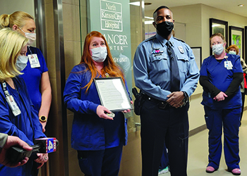 Erin accepts the MoDOT challenge coin