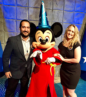 Stephanie and her husband with Mickey