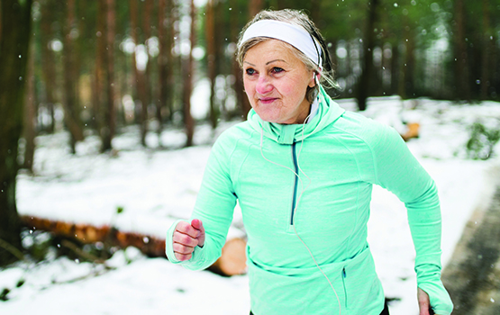 older women power walking in woods