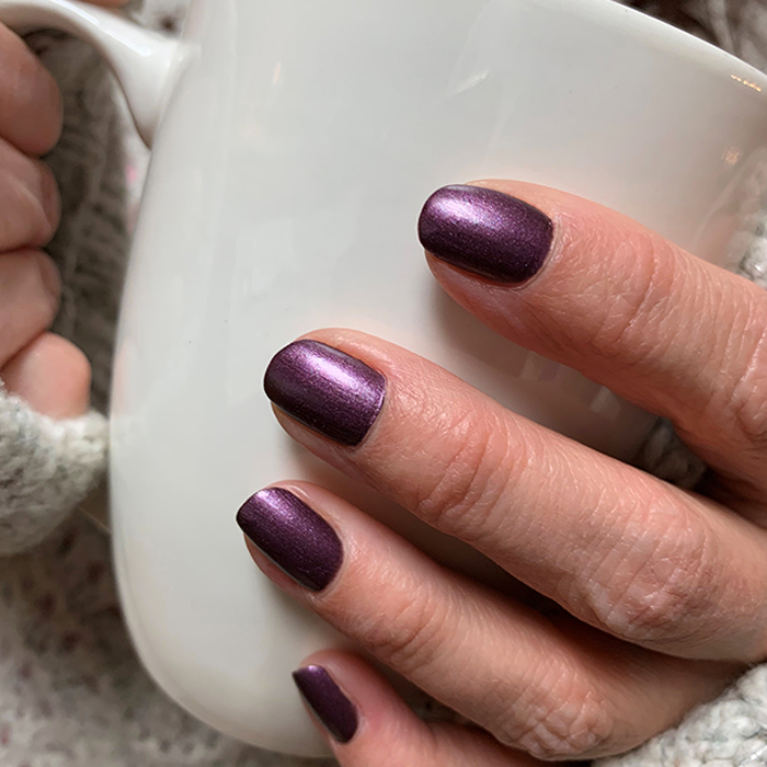 polished nails holding mug