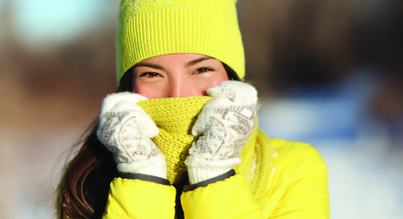 woman wearing a stocking cap, scarf and gloves