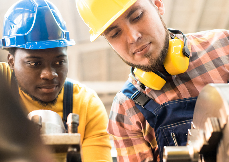 Two men working on machinery