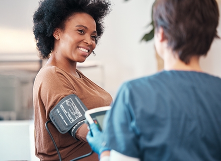 Woman getting blood pressure checked